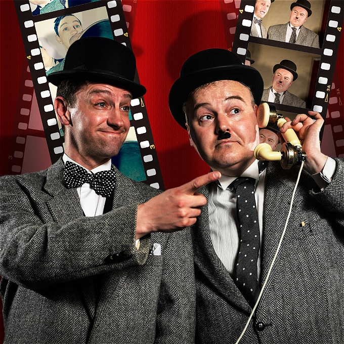Lucky Dog actors as Laurel and Hardy (Stan pointing off, Ollie on a telephone) in front of a red background with film cells.